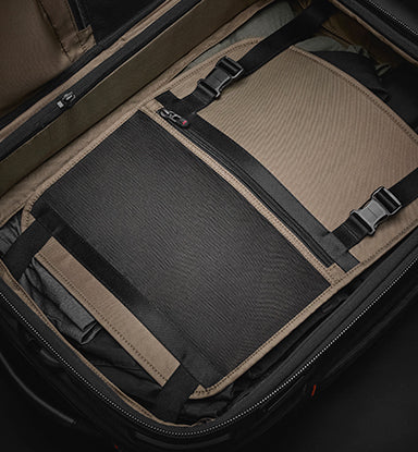 Open suitcase showing internal compression panels