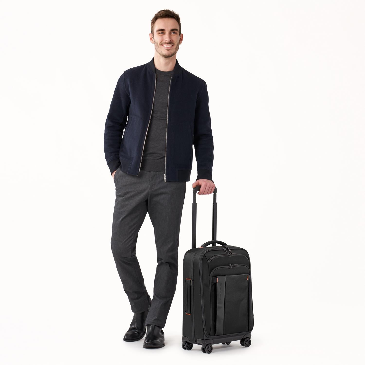 Briggs and Riley ZDX Domestic 22" Carry-On Expandable Spinner Black with Person #color_black