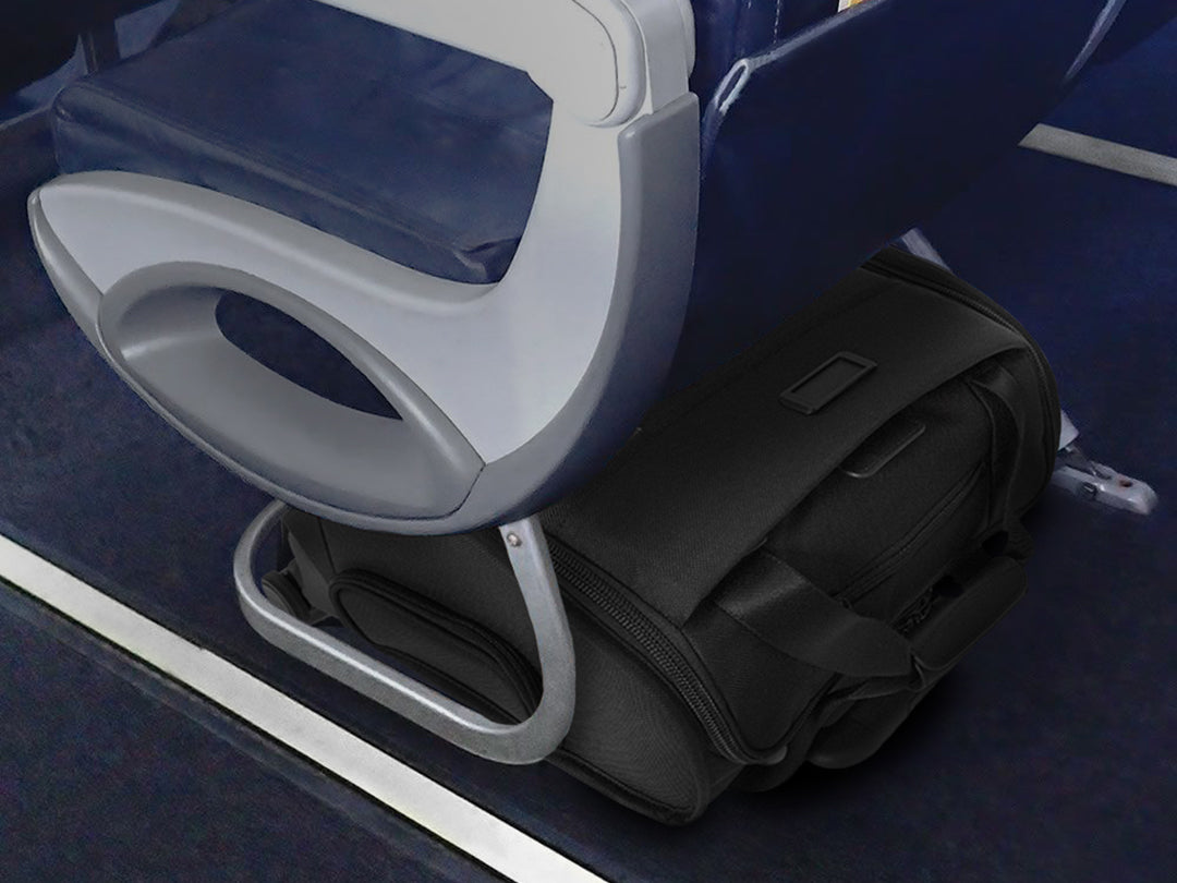 A Briggs & Riley Baseline Underseat Cabin Spinner in black fits easily under an airplane seat.