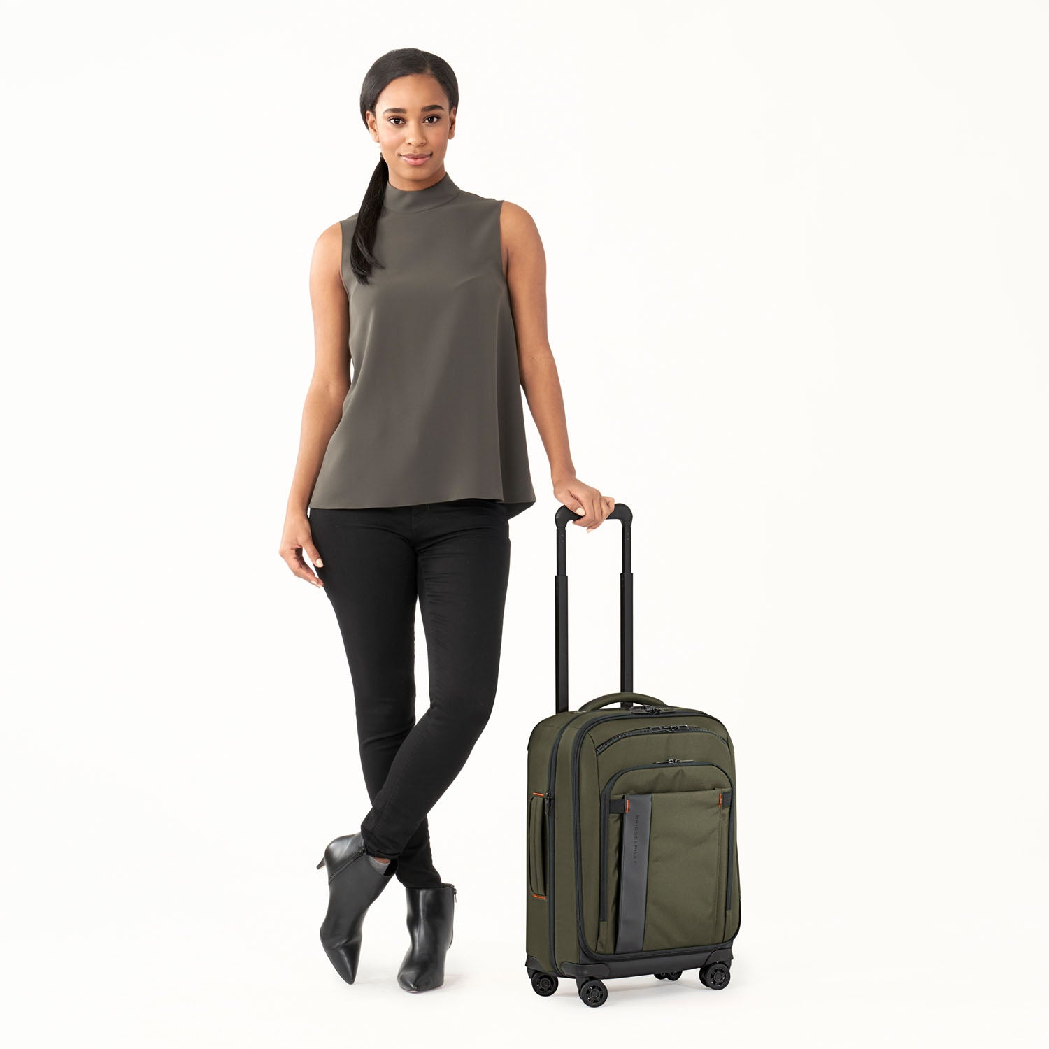 ZDX International 21" Carry-On Expandable Spinner Hunter Front View with Person #color_hunter